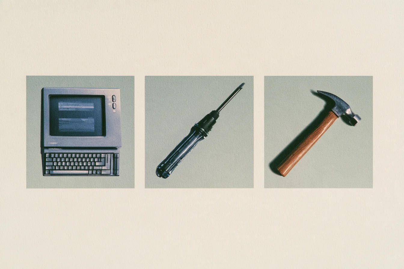 Vintage computer, screwdriver, and hammer on a textured background