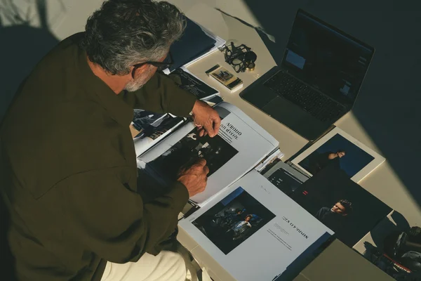 Designer reviewing photographs at a desk