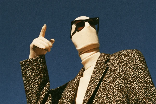 Faceless figure in sunglasses and a suit