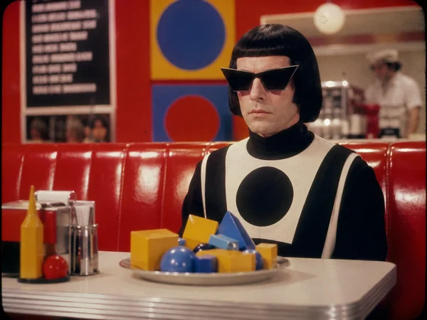 A Person with Geometric Shapes in a Diner