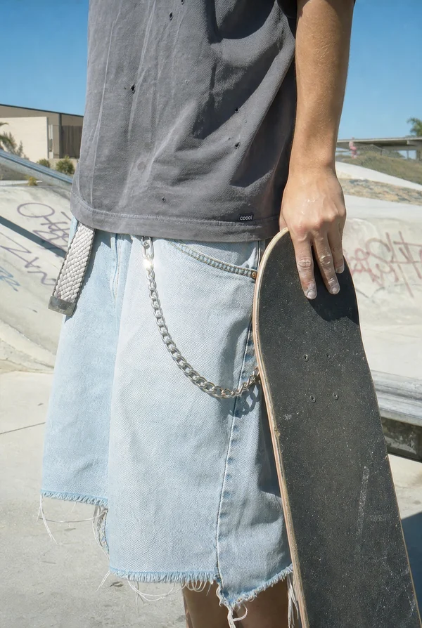 Skater Holding a Skateboard at a Skatepark