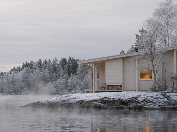 A Modern Wooden Cabin by a Frozen Lake