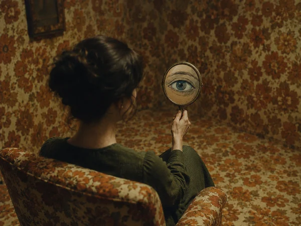 Woman Holding a Mirror with an Eye Illustration