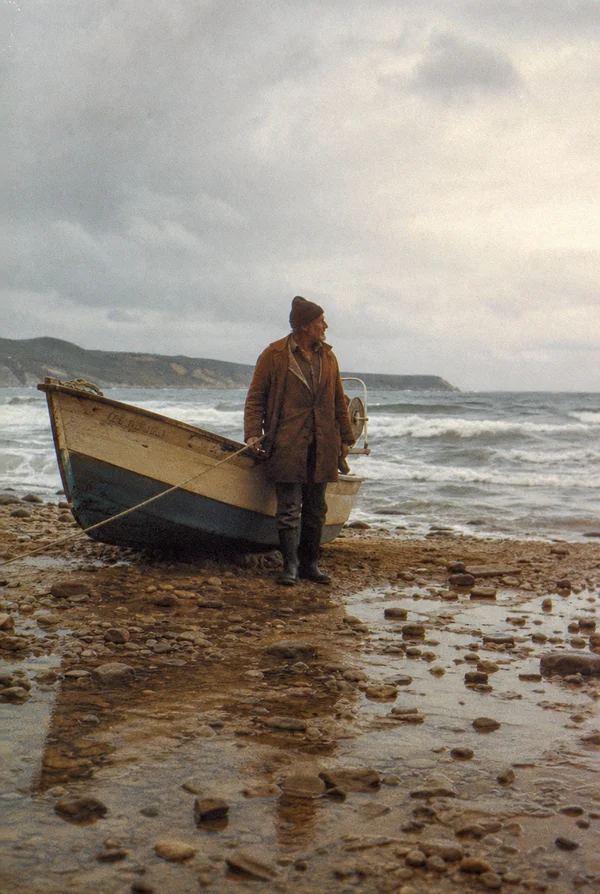 An Elderly Fisherman Standing by His Boat