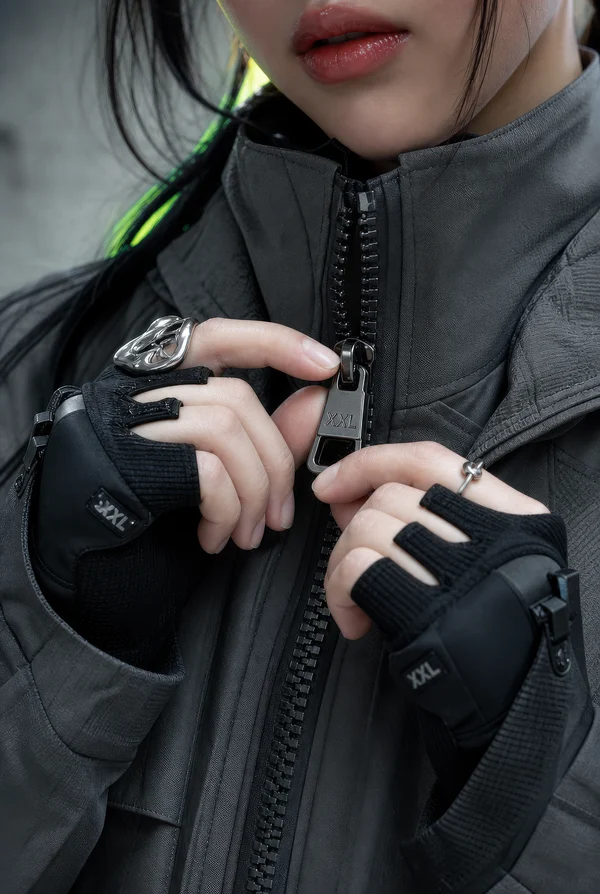 Person Zipping Up a Dark Tactical Jacket