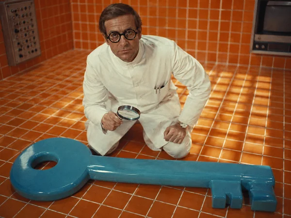 Scientist Examining a Giant Blue Key