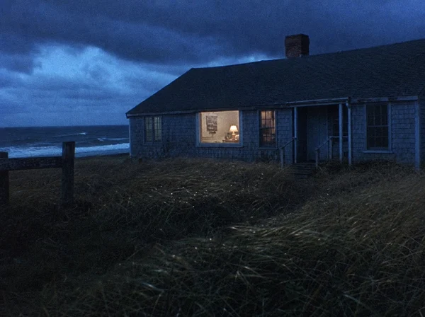 A lonely cottage by the sea at twilight