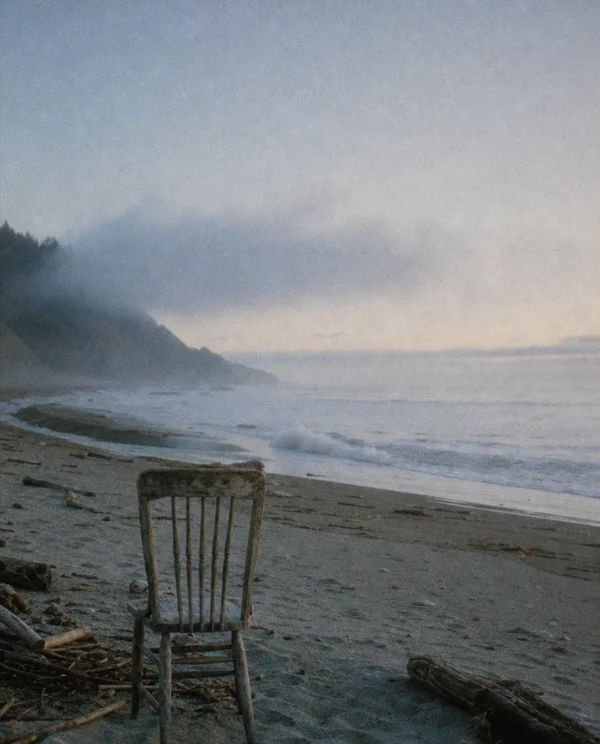 An Empty Chair on a Misty Beach