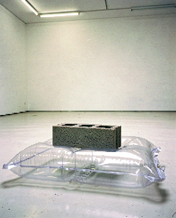 A Concrete Block Resting on an Inflatable Pillow