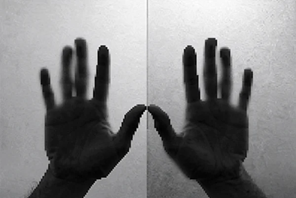 Silhouettes of Hands Pressed Against Glass