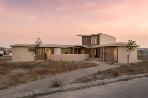 Modern Curved Concrete House at Sunset
