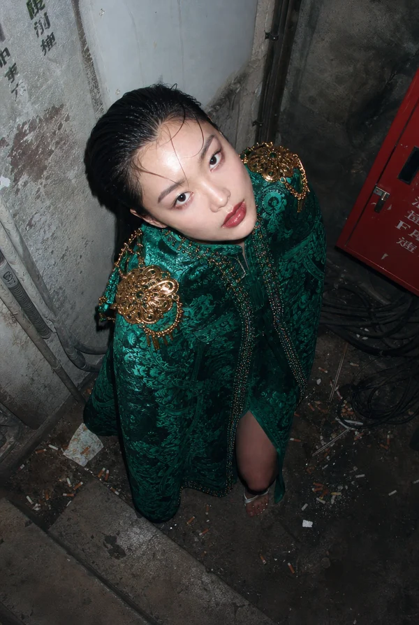 Woman in an Ornate Green Cape
