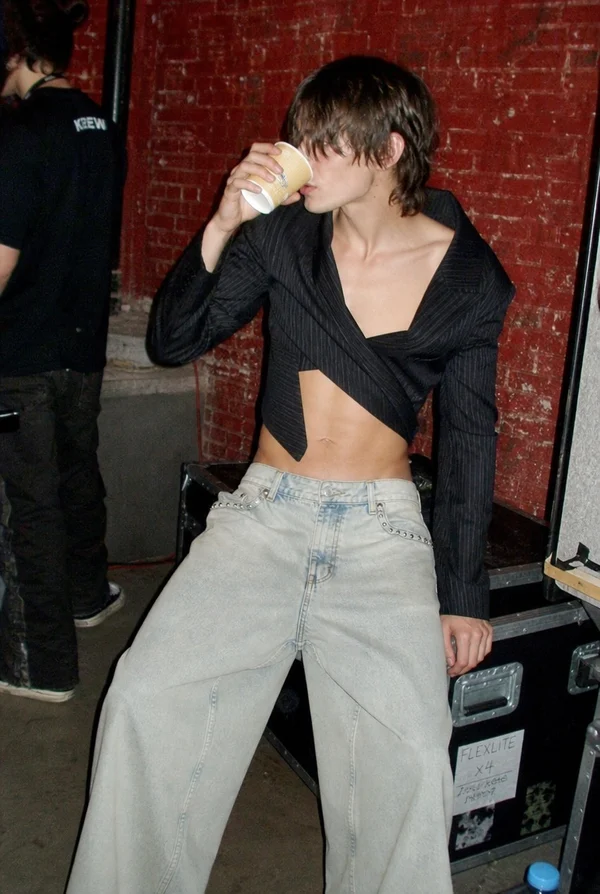 Young Person Drinking from a Cup Backstage