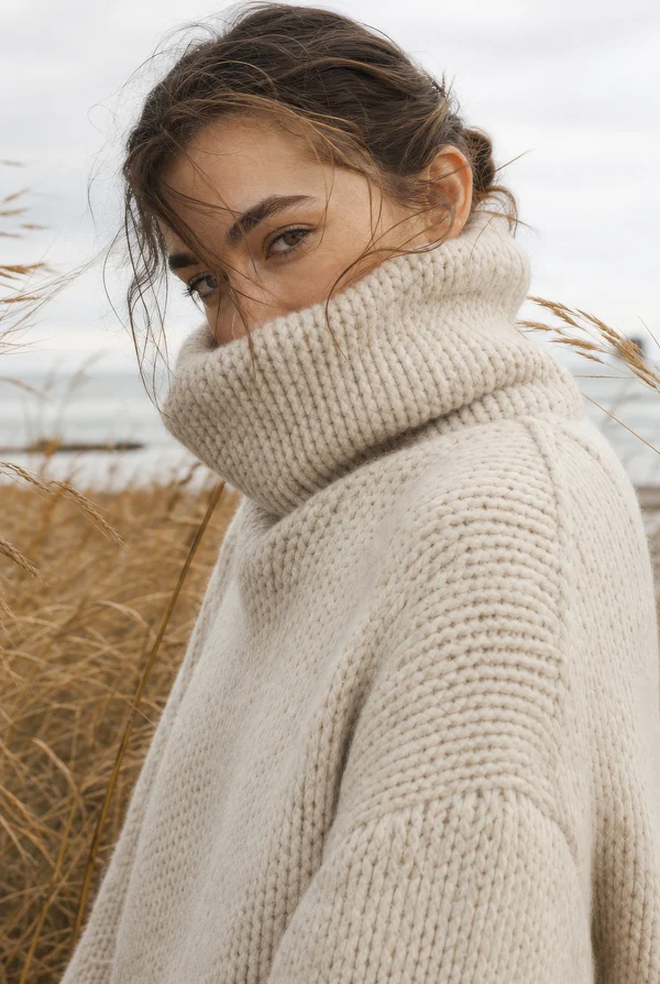 Woman in a Cozy Knit Sweater by the Coast