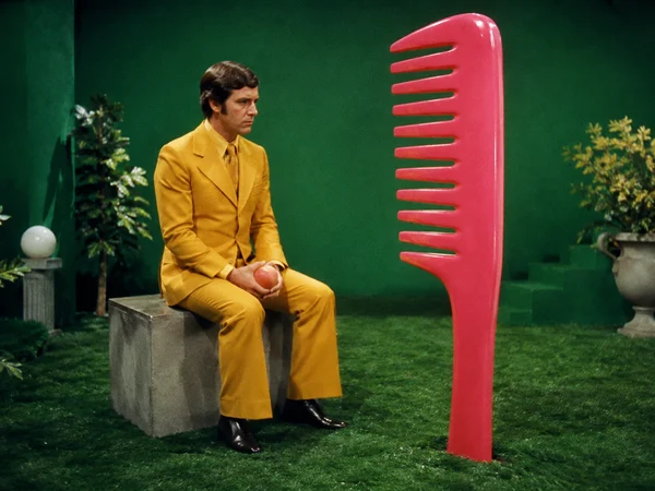 Man in Yellow Suit with Giant Pink Comb