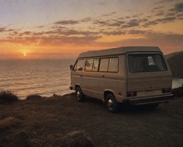 Van parked by the ocean at sunset