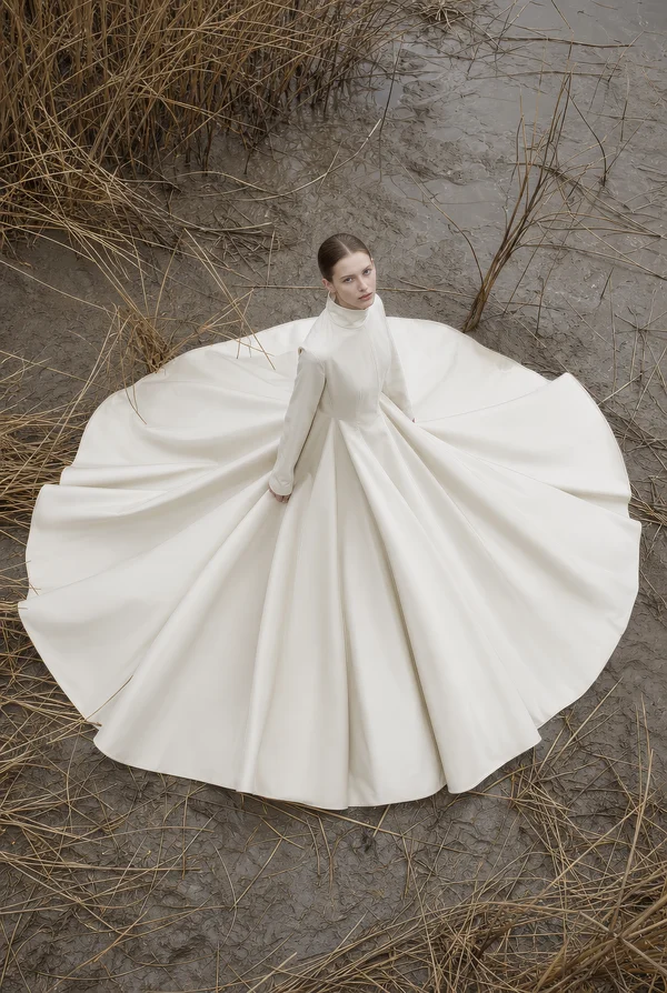 Woman in a White Gown Standing in a Field