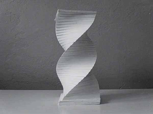 A Twisted Paper Sculpture on a Table