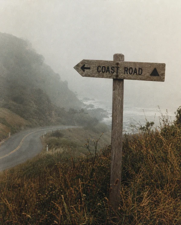 A Foggy Coastal Road Sign