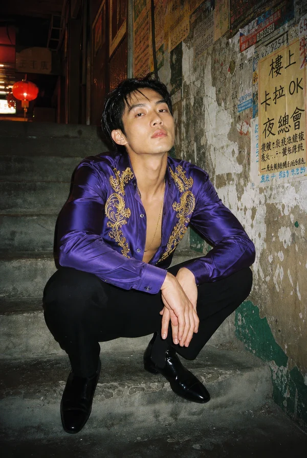 A Young Man Posing on Stone Steps