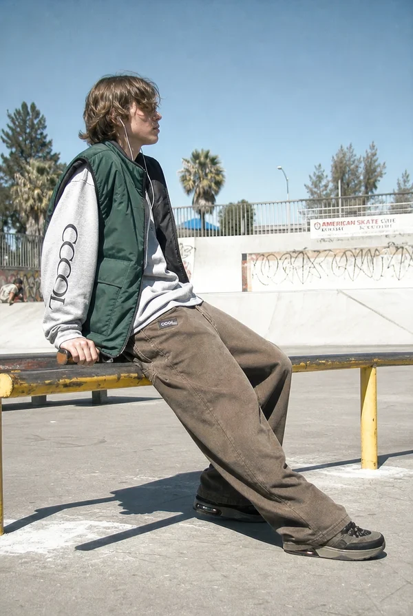 Young Skater Resting at the Skatepark