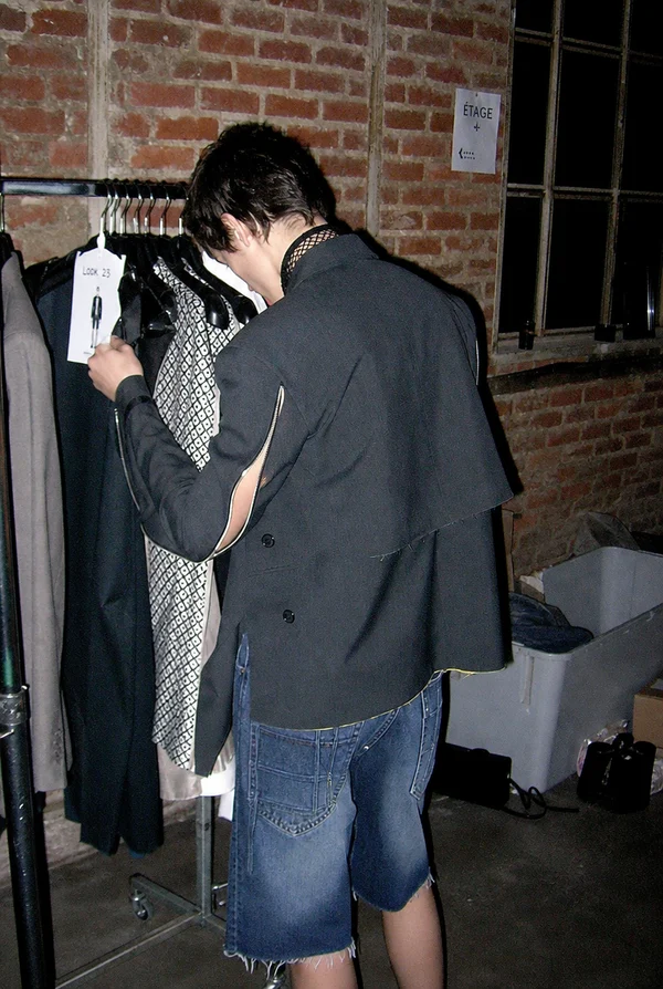 Person selecting clothing from a rack