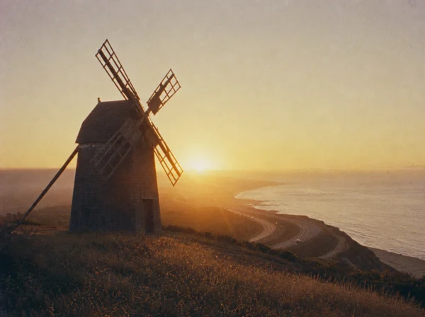 Windmill Overlooking the Coast at Sunset