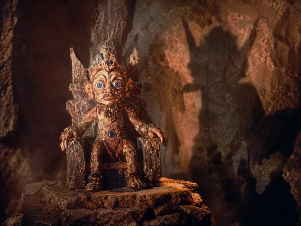 A Grotesque Figure Seated on a Stone Throne