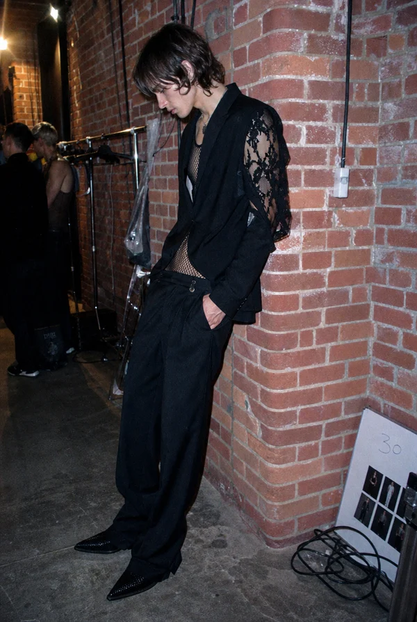 Fashion Model Leaning Against a Brick Wall