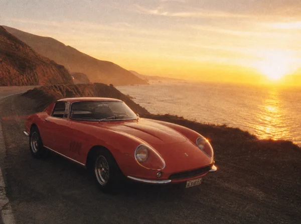 Classic Red Sports Car at Sunset by the Coast