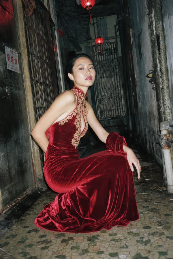 Woman in Red Velvet Dress in Urban Alleyway