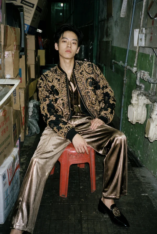 A Young Man in Ornate Gold and Black Attire