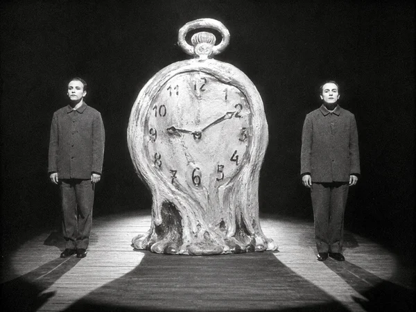 Two Figures Standing Beside a Melting Clock