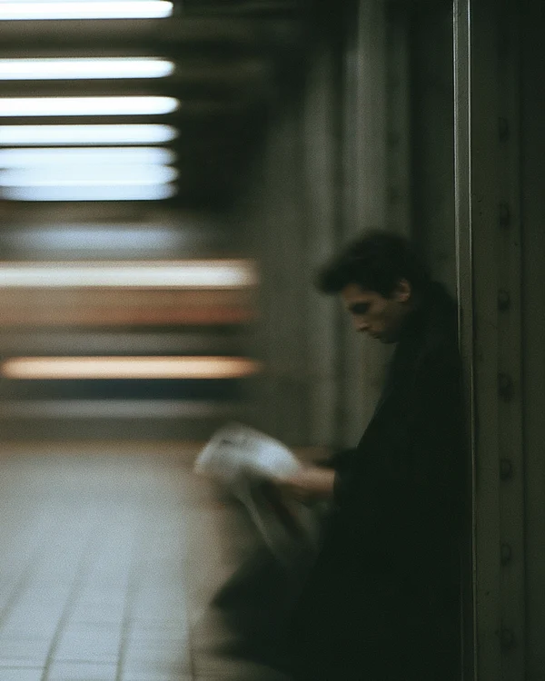 Commuter Reading on a Subway Platform