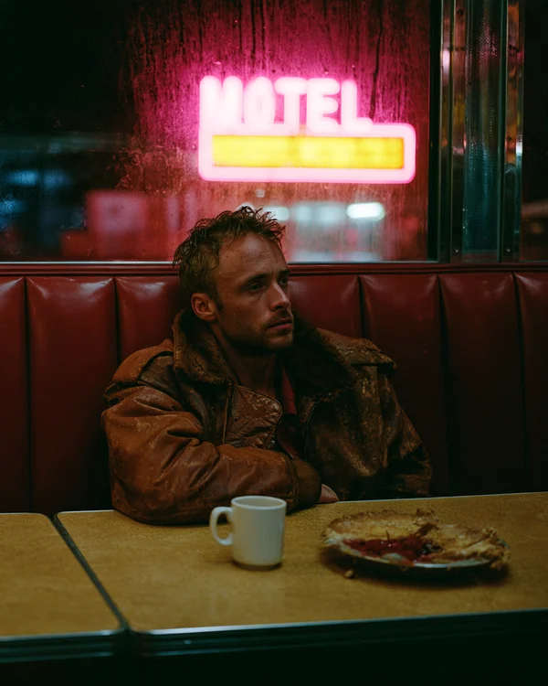 Man Sitting Alone in a Roadside Diner at Night
