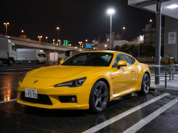 Yellow Sports Coupe Parked at Night