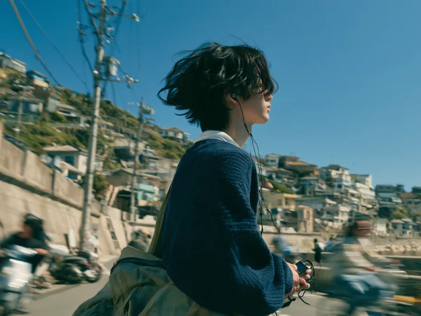 Young Man Standing in a Coastal Town