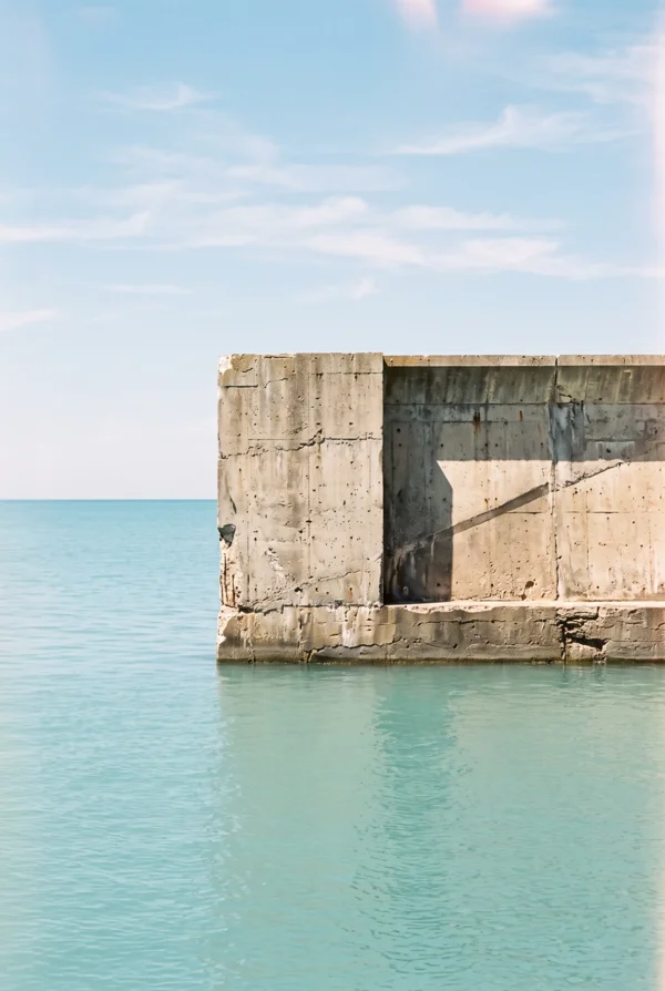 Concrete Seawall Meeting the Turquoise Ocean