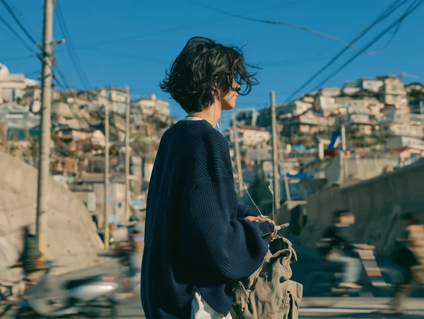 A Young Man Standing in a Coastal Town