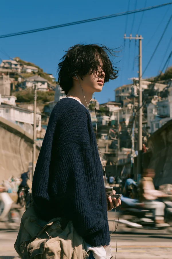 Young Man Standing in a Coastal Town