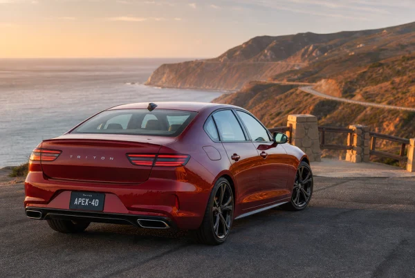 Red Sedan Parked at a Coastal Scenic Overlook