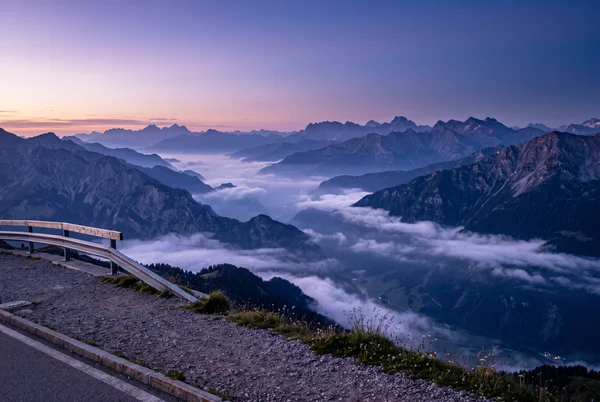 Twilight View Over Mountain Ridges and Fog
