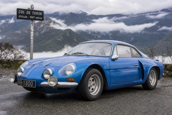 Blue Sports Coupe on a Mountain Pass