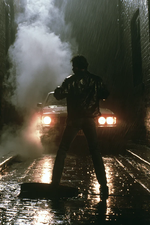 Man Standing in a Rainy Alleyway at Night