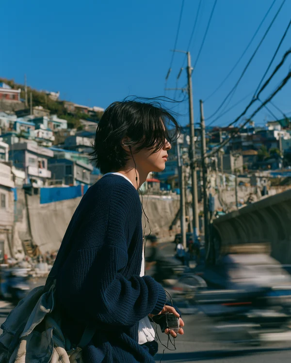 Young Man Standing in a Coastal Town