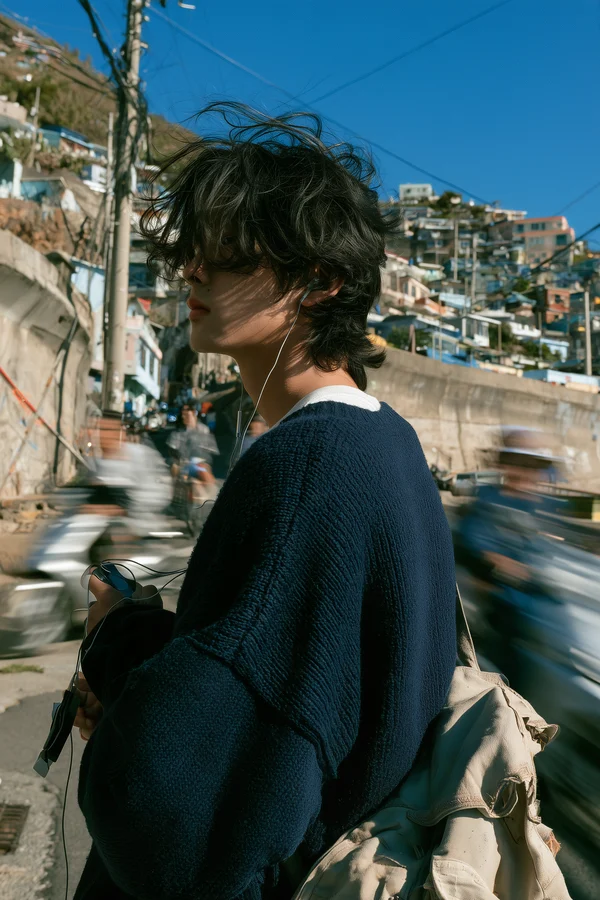 Young Man Standing in a Coastal Town