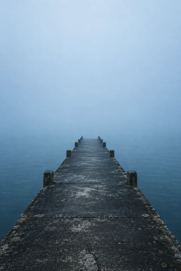 Concrete Pier Extending Into Misty Horizon