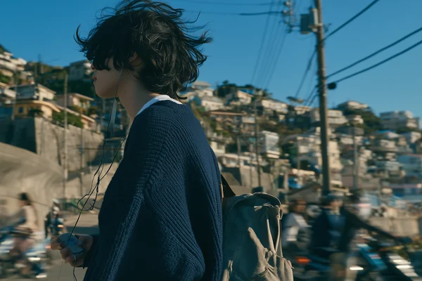 Young Man Standing in a Coastal Town