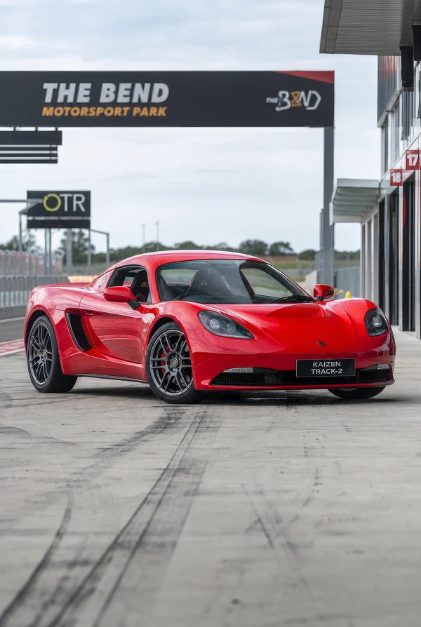 Red Sports Car Parked at a Racetrack Pit Lane