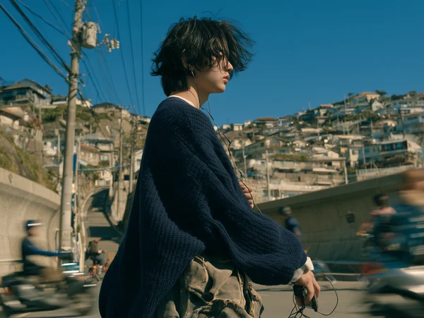 Young Man Standing in a Coastal Town